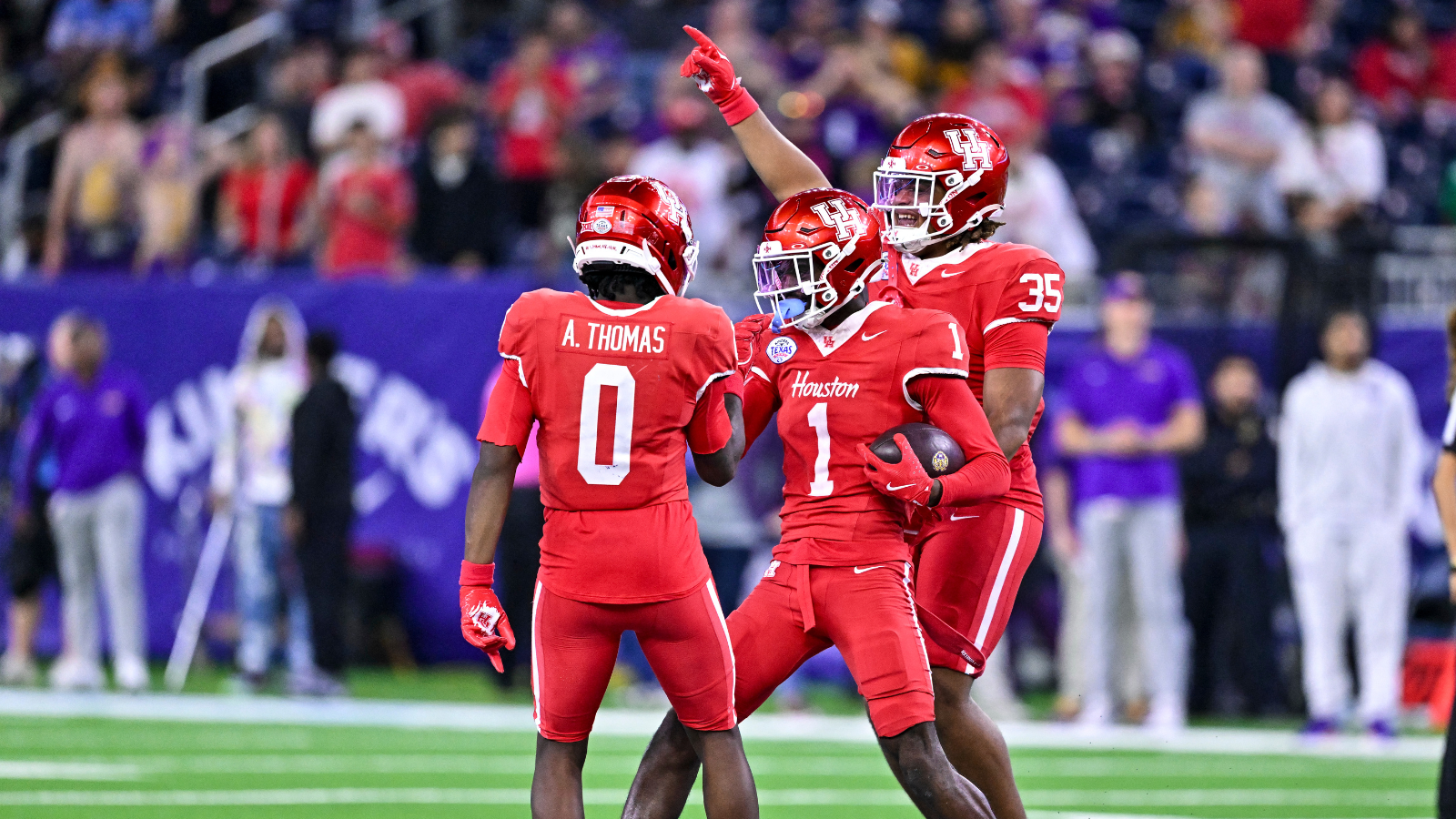 Dec 27, 2025; Houston, TX, USA; Houston Cougars defensive back Blake Thompson (0) and defensive back Latrell McCutchin Sr. (1) reacts during the second half against the Louisiana State Tigers at NRG Stadium.