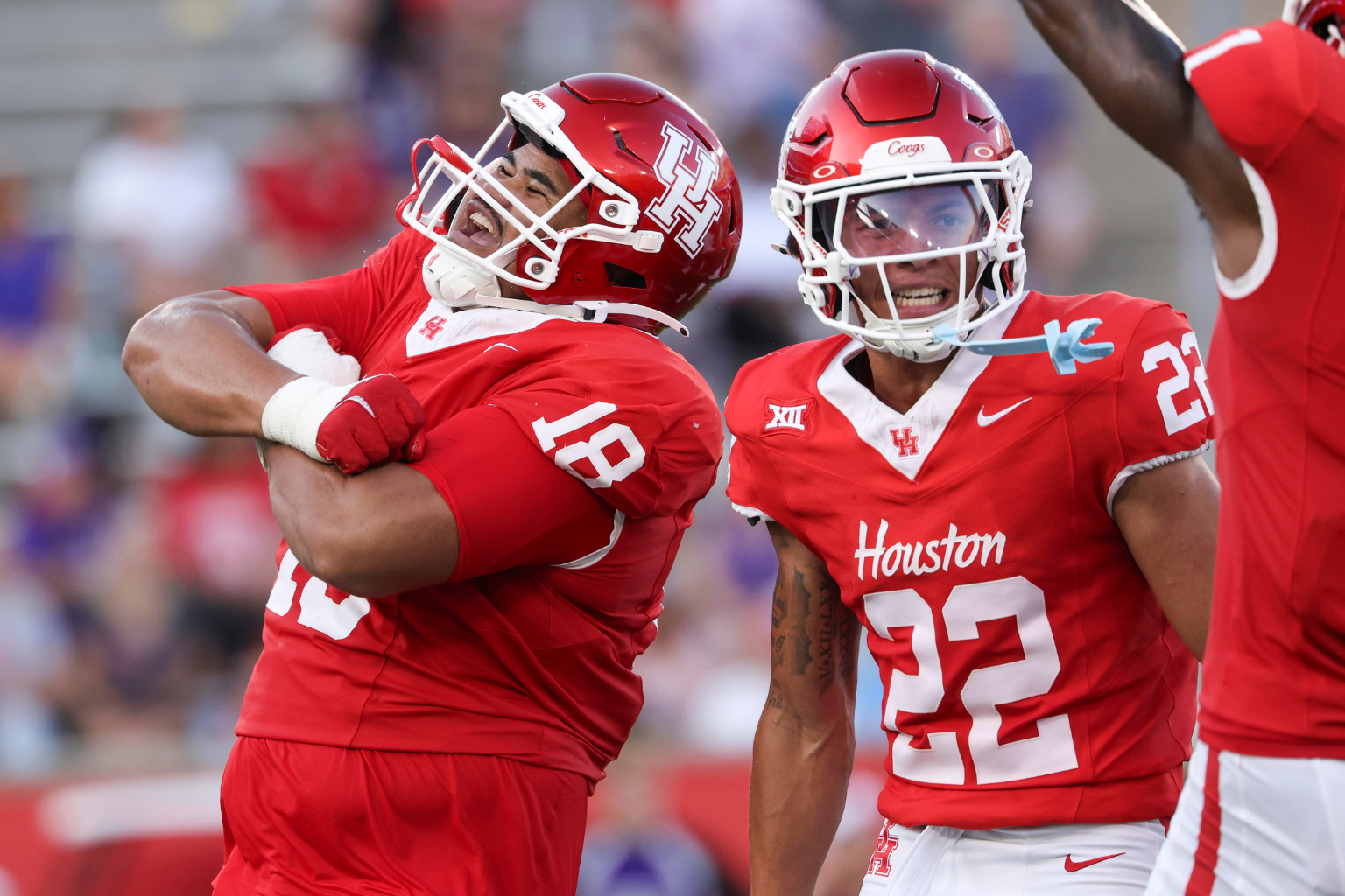 Aug 28, 2025; Houston, Texas, USA; Houston Cougars defensive lineman Khalil Laufau (18) celebrates with defensive back Marc Stampley II (22) after a defenisve play during the first quarter against the Stephen F. Austin Lumberjacks at TDECU Stadium