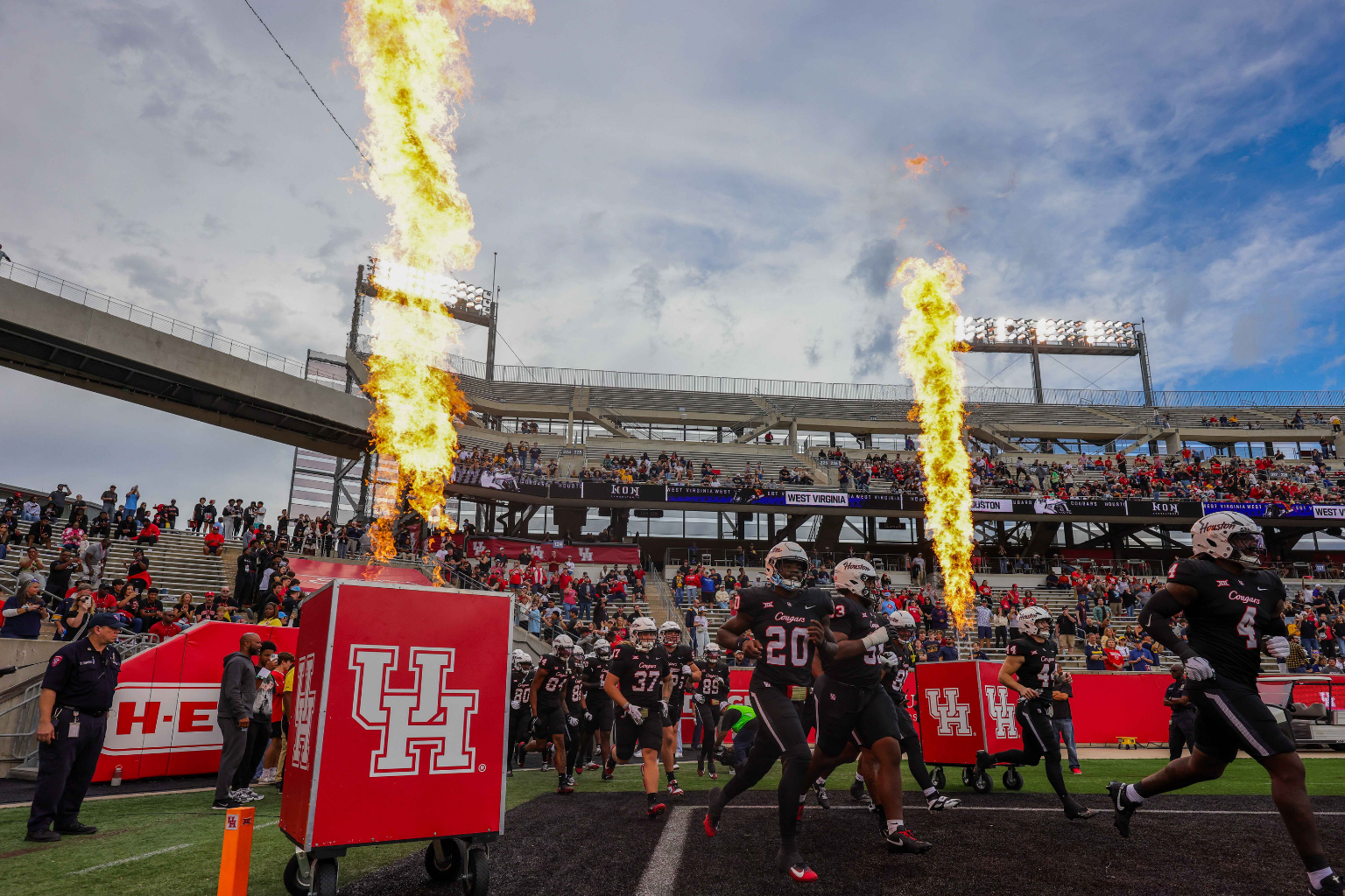 Nov 1, 2025; Houston, Texas, USA; The Houston Cougars run out onto the field before playing against the West Virginia Mountaineers at TDECU Stadium.