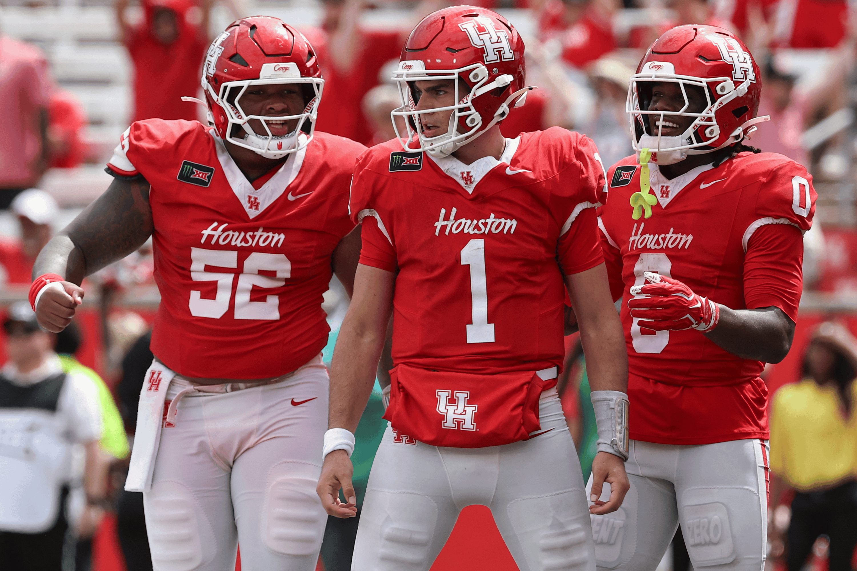 Sep 5, 2026; Houston, Texas, USA; Houston Cougars quarterback Conner Weigman (1) reacts with offensive lineman Anthony Boswell (52) and wide receiver Amare Thomas (0) after a play during the fourth quarter against the Oregon State Beavers at TDECU Stadium