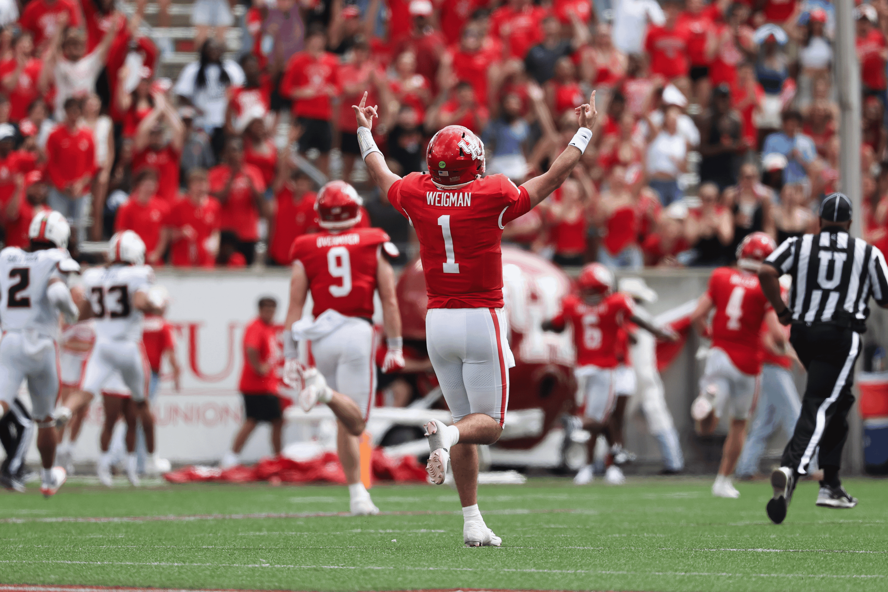 Sep 5, 2026; Houston, Texas, USA; Houston Cougars quarterback Conner Weigman (1) reacts as running back Re'shaun Sanford II (6) runs for a touchdown during the second quarter against the Oregon State Beavers at TDECU Stadium.