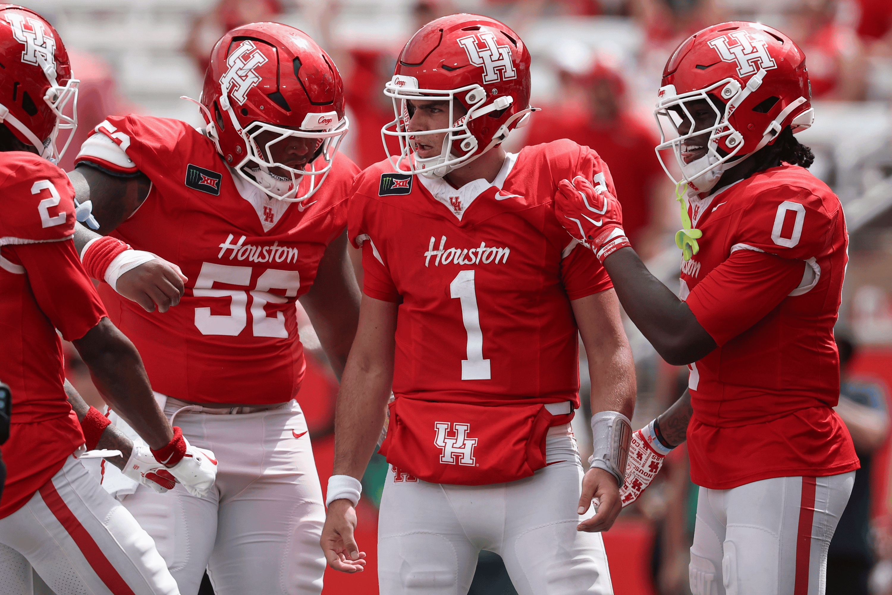 Sep 5, 2026; Houston, Texas, USA; Houston Cougars quarterback Conner Weigman (1) reacts with offensive lineman Anthony Boswell (52) and wide receiver Amare Thomas (0) after a play during the fourth quarter against the Oregon State Beavers at TDECU Stadium.
