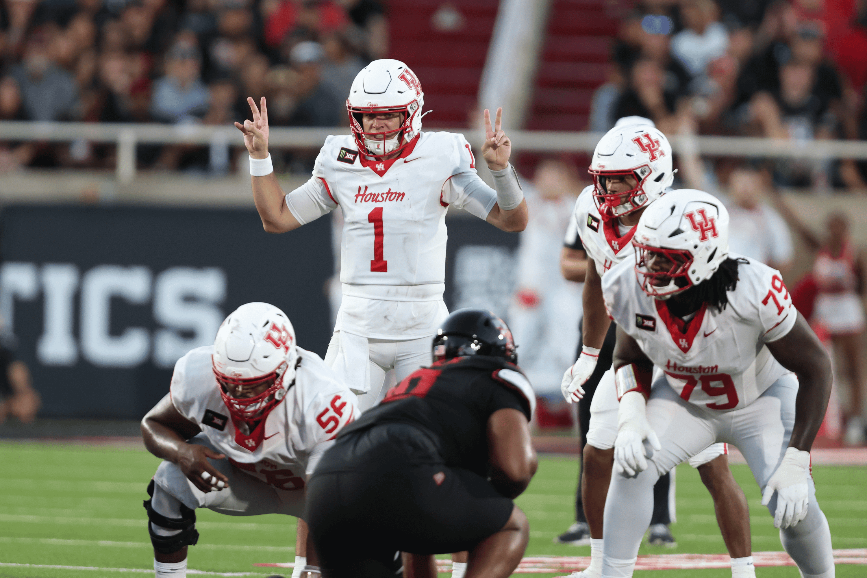 Sep 18, 2026; Lubbock, Texas, USA; Houston Cougars quarterback Conner Weigman (1) signals against the Texas Tech Red Raiders defense in the first half at Galaxy Stadium.