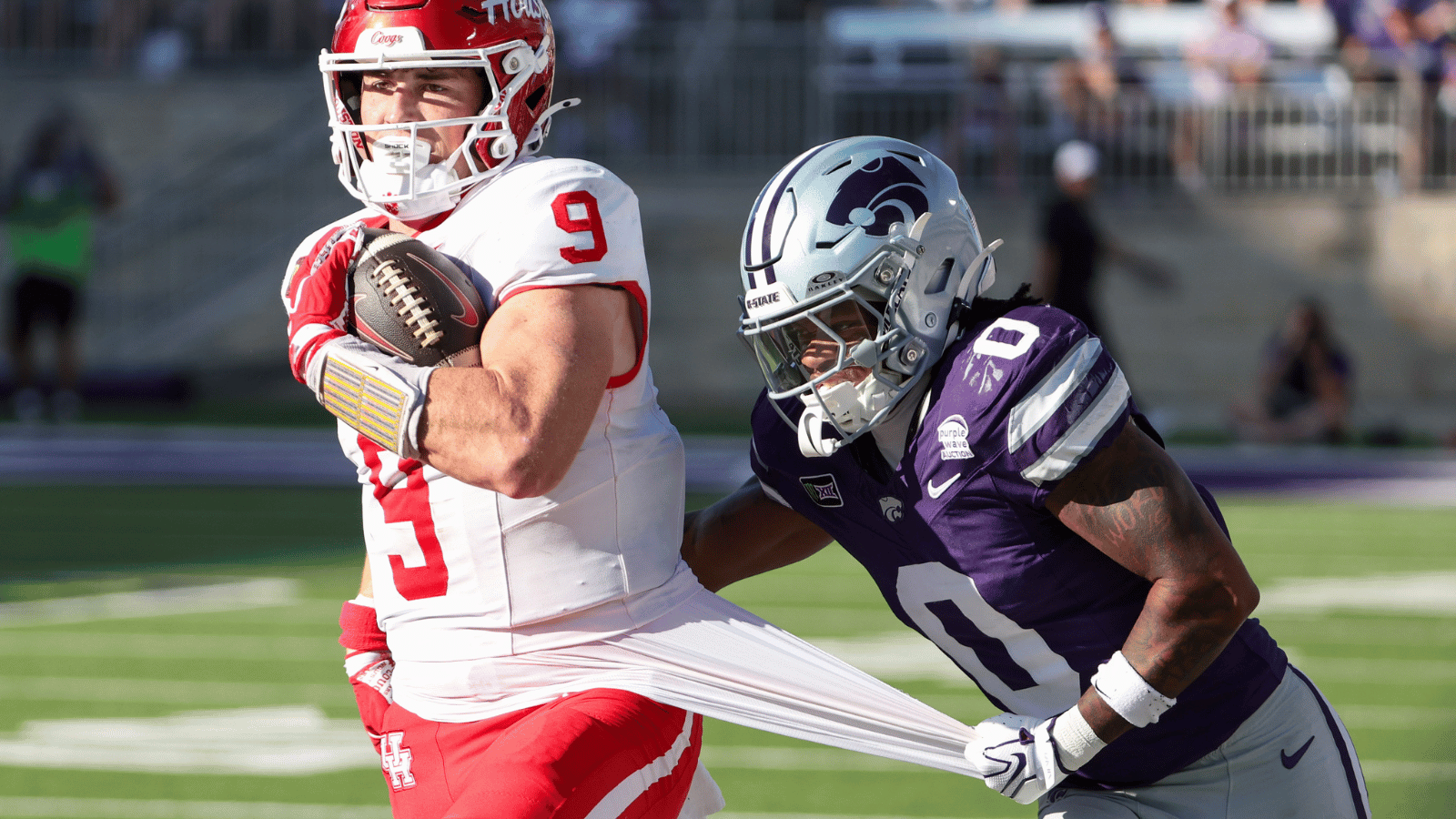 Oct 10, 2026; Manhattan, Kansas, USA; Houston Cougars tight end Patrick Overmyer (9) is tackled by Kansas State Wildcats cornerback Donovan McIntosh (9) during the second quarter at Bill Snyder Family Football Stadium