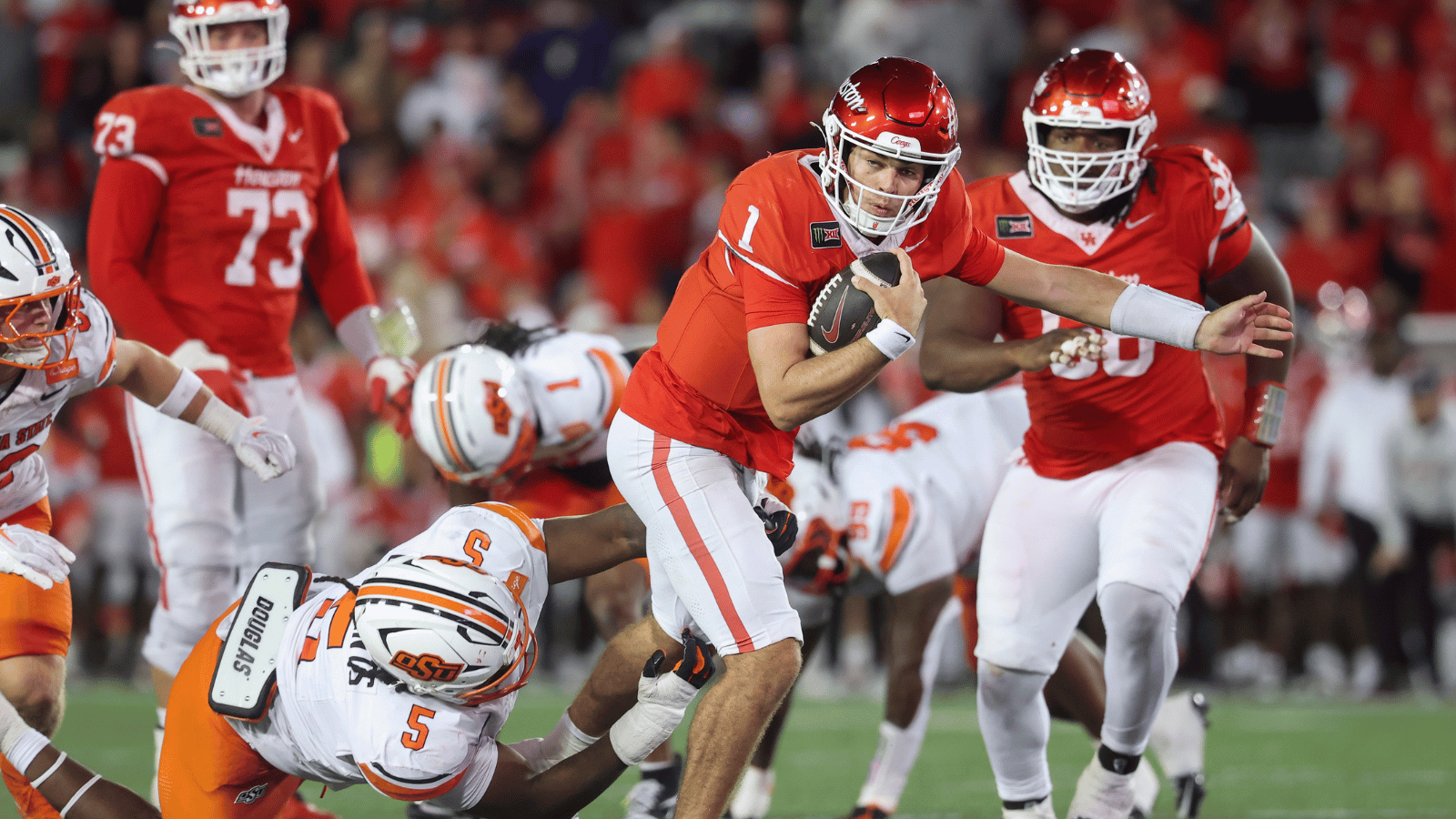 Oct 17, 2026; Houston, Texas, USA; Houston Cougars quarterback Conner Weigman (1) runs with the ball for a first down as Oklahoma State Cowboys defensive tackle Saadiq Clements (5) attempts to make a tackle during the fourth quarter at TDECU Stadium